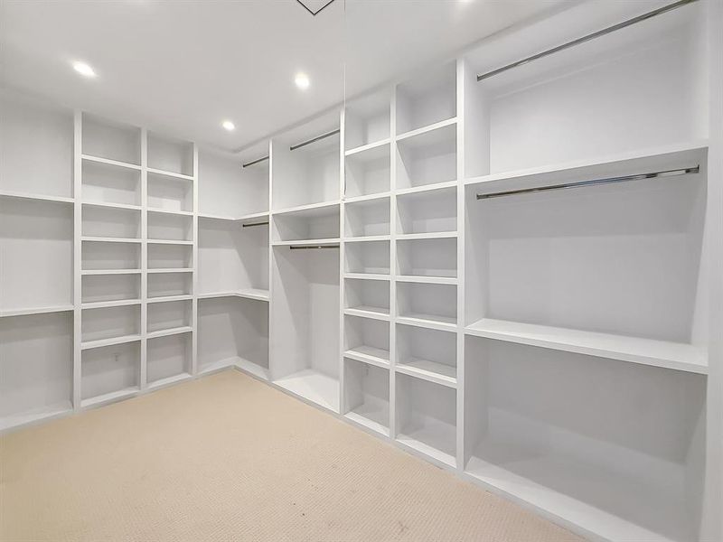 Walk in closet featuring light carpet Walk in closet featuring light carpet