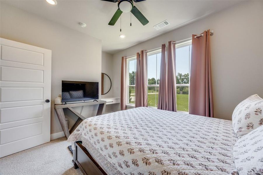Bedroom featuring light carpet, recessed lighting, and a ceiling fan