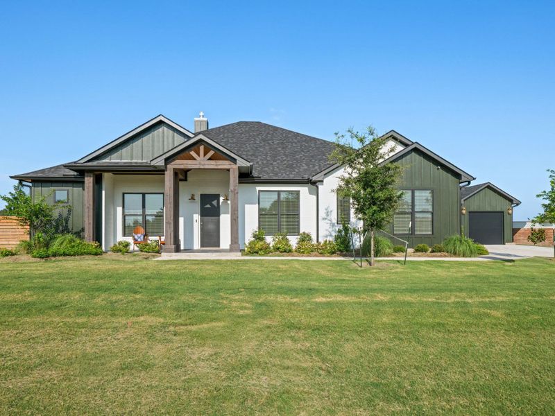 Front exterior of a new home in , Smithville, TX, highlighting curb appeal (Image 25).