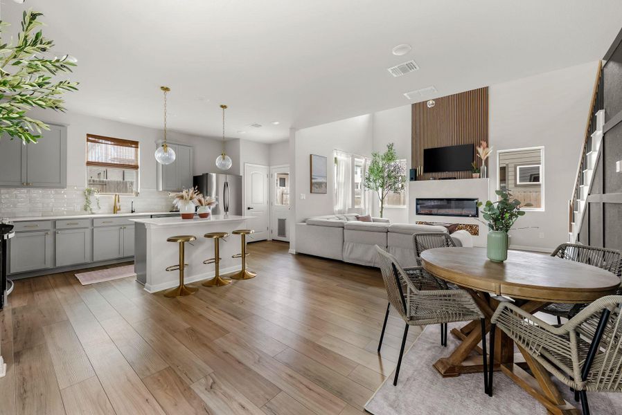 Dining room with a fireplace and light wood-style floors