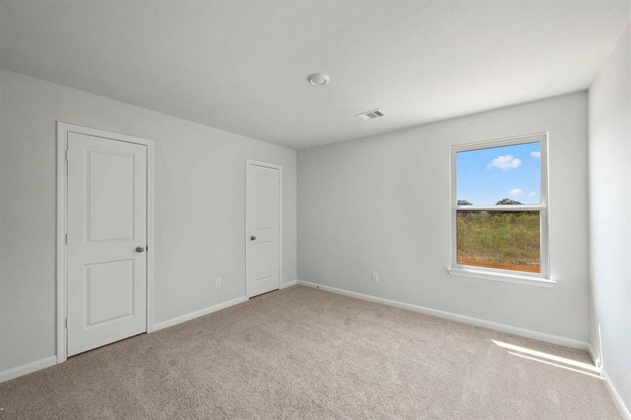 One of the two additional bedrooms in the home.