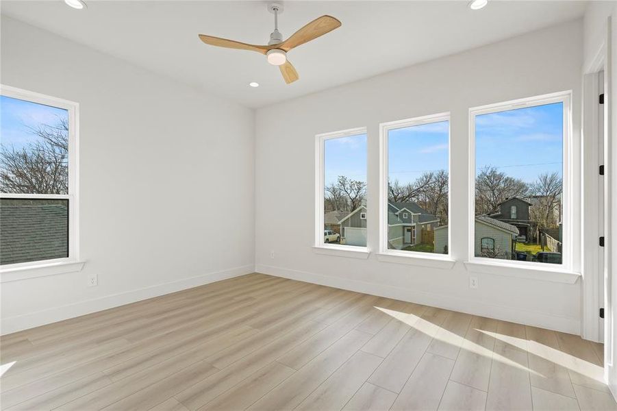 Unfurnished room with ceiling fan, light wood-style floors, and recessed lighting Unfurnished room with ceiling fan, light wood-style floors, and recessed lighting