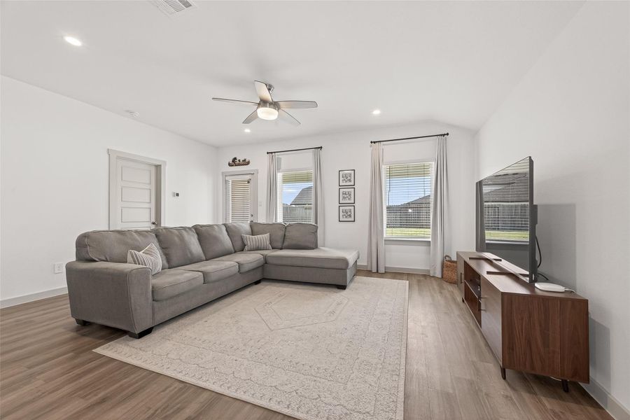 Living room area, door to the left leads into the primary bedroom, door straight ahead leads to back patio. Living room area, door to the left leads into the primary bedroom, door straight ahead leads to back patio.
