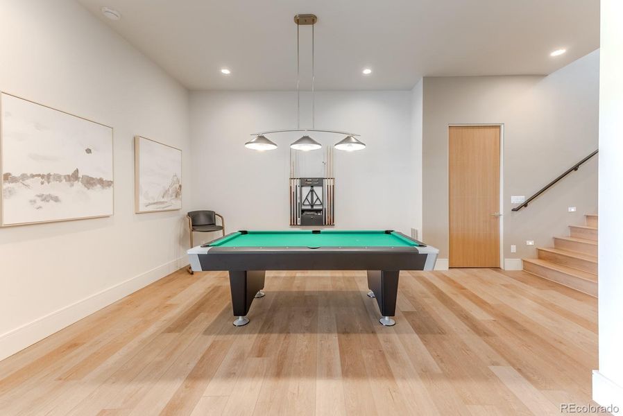 The billiards zone offers an inviting space for casual play and conversation, designed to flow effortlessly into the adjoining entertainment areas.