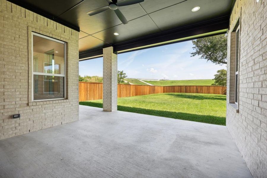 View of patio featuring ceiling fan