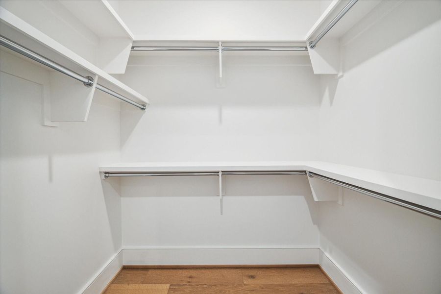One of the two large walk-in primary closet. Photos are of a similar unit with the same floor plan One of the two large walk-in primary closet. Photos are of a similar unit with the same floor plan