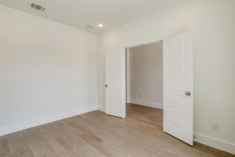 Unfurnished bedroom with light wood-type flooring