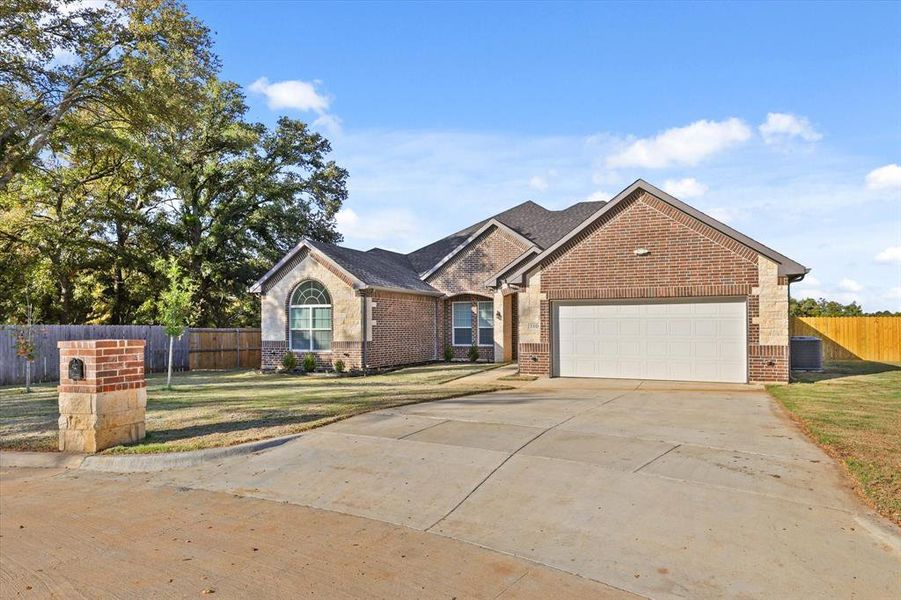 View of front of house with a front yard and a garage