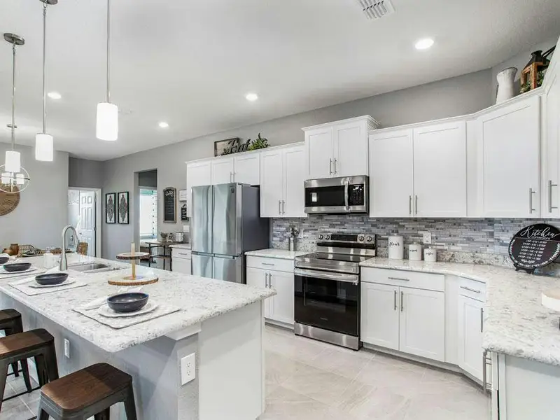 Your well-appointed kitchen provides plenty of cabinet and counter space - Waylyn by Highland Homes