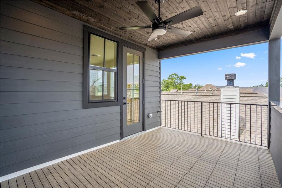 Custom covered patio with wood tiles and wood ceiling. Ceiling fan here for maximum comfort.