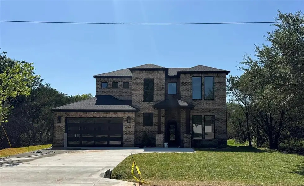 Front exterior of a new home in , Whitney, TX, highlighting curb appeal (Image 1). Front exterior of a new home in , Whitney, TX, highlighting curb appeal (Image 1).