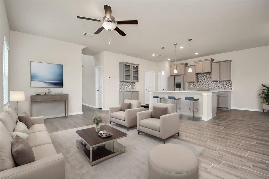 Step inside and take in the open floor plan allowing for ease of flow between living, dining and kitchen spaces. Note the recessed lighting complimented with elegant light fixtures **This image is from another Saratoga Home with similar floor plan and finishes, not the Brittany floorplan.**