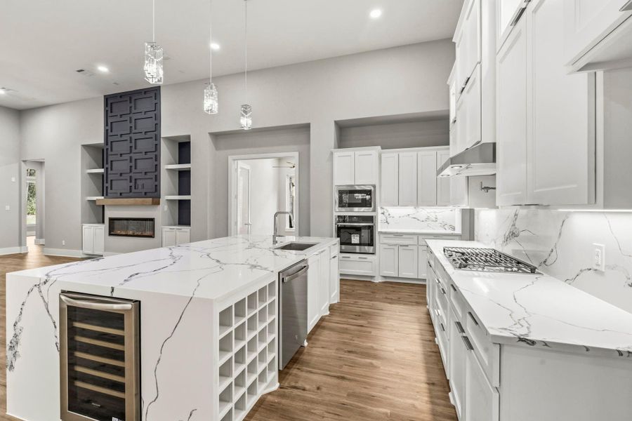 Built for entertaining. Features include a wine fridge and dedicated wine storage.