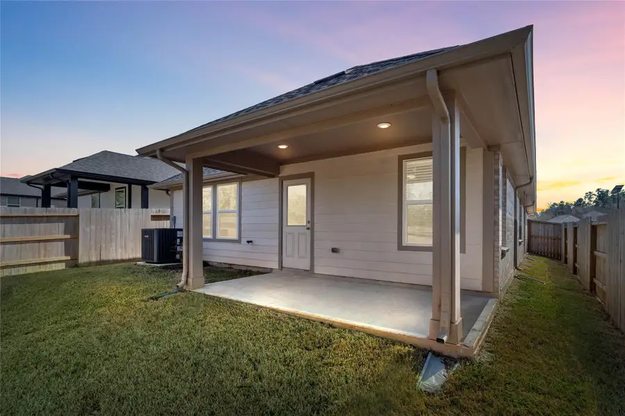 Enjoy the outdoors! A covered patio with integrated recessed lighting offers a space for entertaining guests or relaxing.