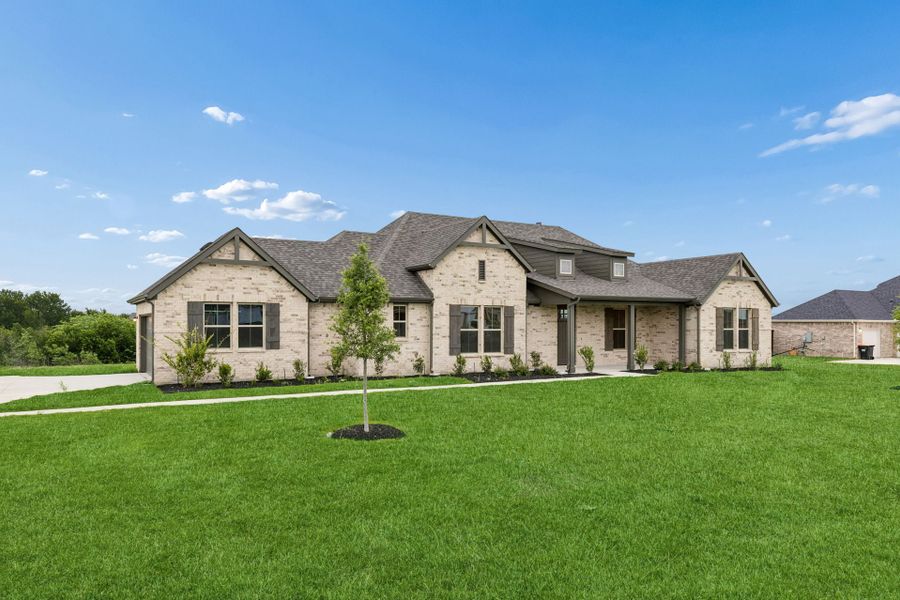 Front exterior of a new home in Ellis Ranch Estates, Waxahachie, TX, highlighting curb appeal (Image 2). Front exterior of a new home in Ellis Ranch Estates, Waxahachie, TX, highlighting curb appeal (Image 2).
