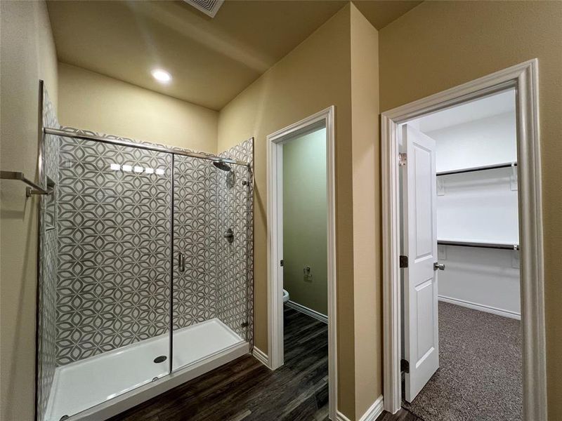 Bathroom with a stall shower, toilet closet, and Walk-in Closet
