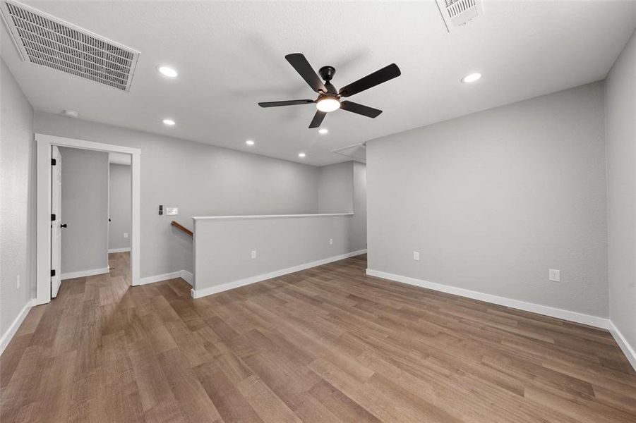 Spare room with ceiling fan, wood finished floors, and recessed lighting Spare room with ceiling fan, wood finished floors, and recessed lighting
