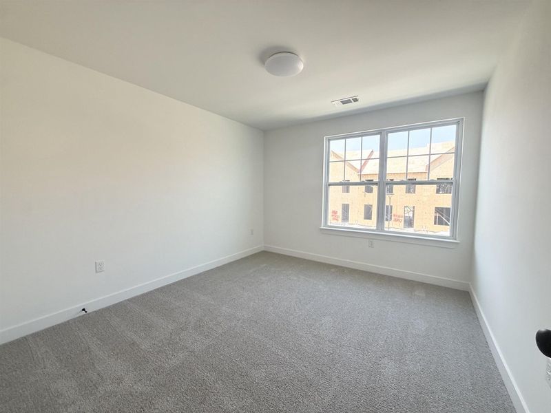 Carpeted spare room with baseboards