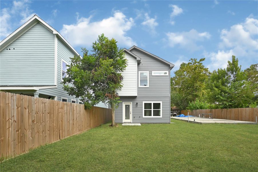 Lush green space and privacy fence, ideal for outdoor enjoyment. Lush green space and privacy fence, ideal for outdoor enjoyment.