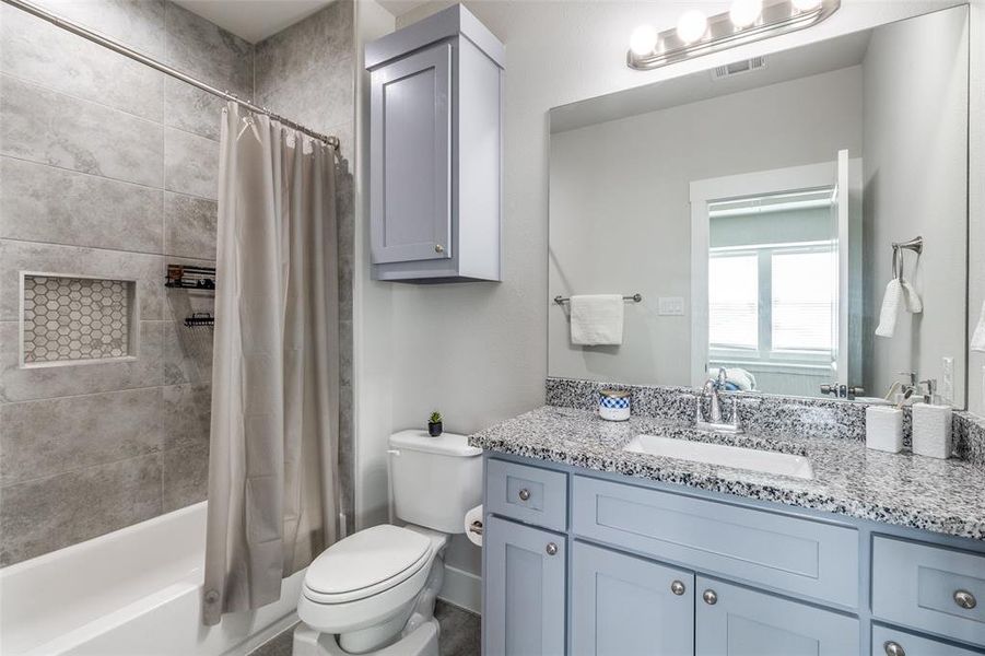 Bathroom featuring shower / bath combo and vanity
