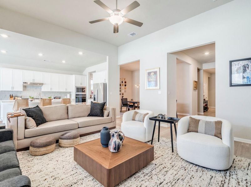 An inviting open-concept layout seamlessly connects the living space to the kitchen and dining areas.