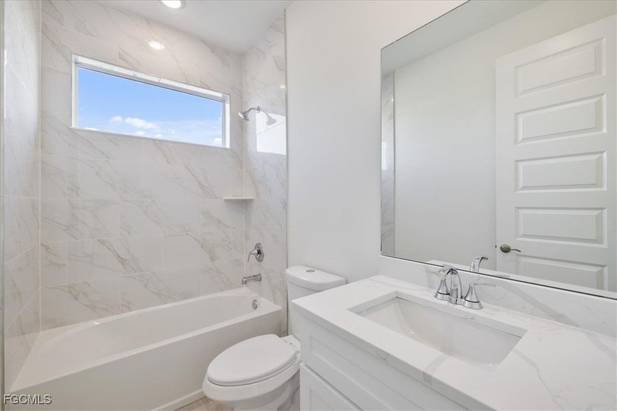Full bath featuring vanity and  shower combination