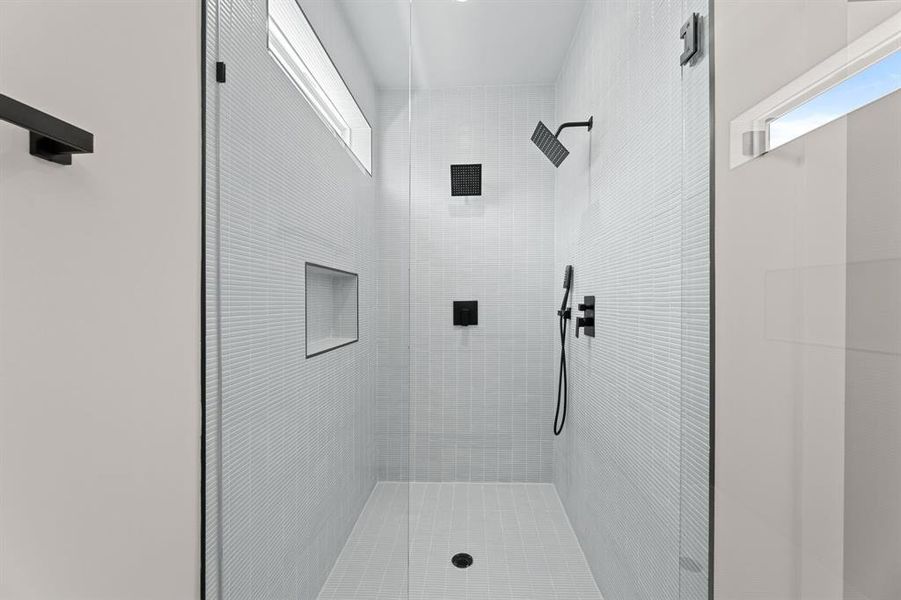 Primary bathroom with double showerhead shower.