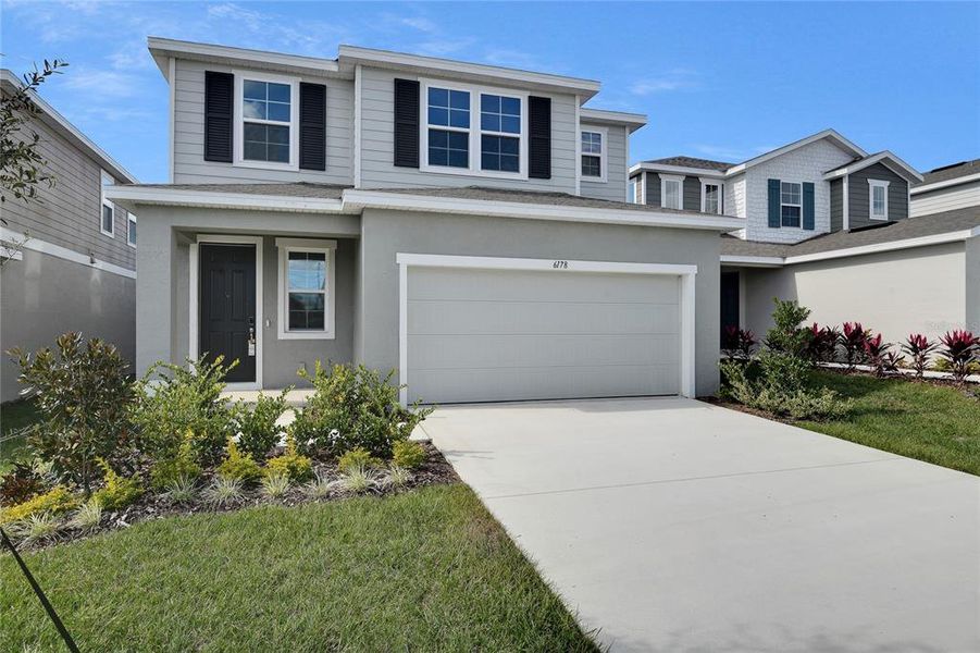 Front exterior of a new home in Seasons at Scenic Terrace, Lake Hamilton, FL, highlighting curb appeal (Image 2). Front exterior of a new home in Seasons at Scenic Terrace, Lake Hamilton, FL, highlighting curb appeal (Image 2).