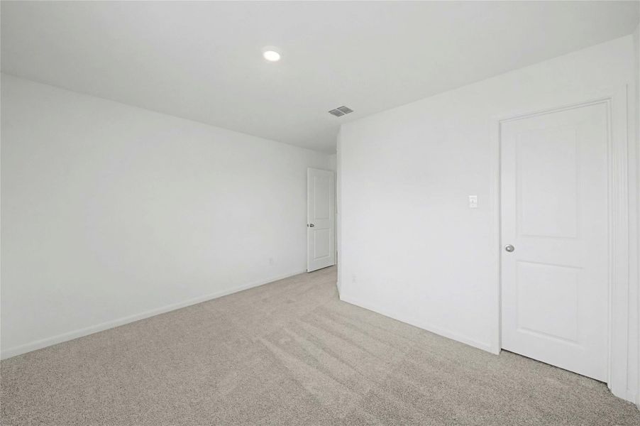 Unfurnished bedroom featuring light colored carpet and recessed lighting