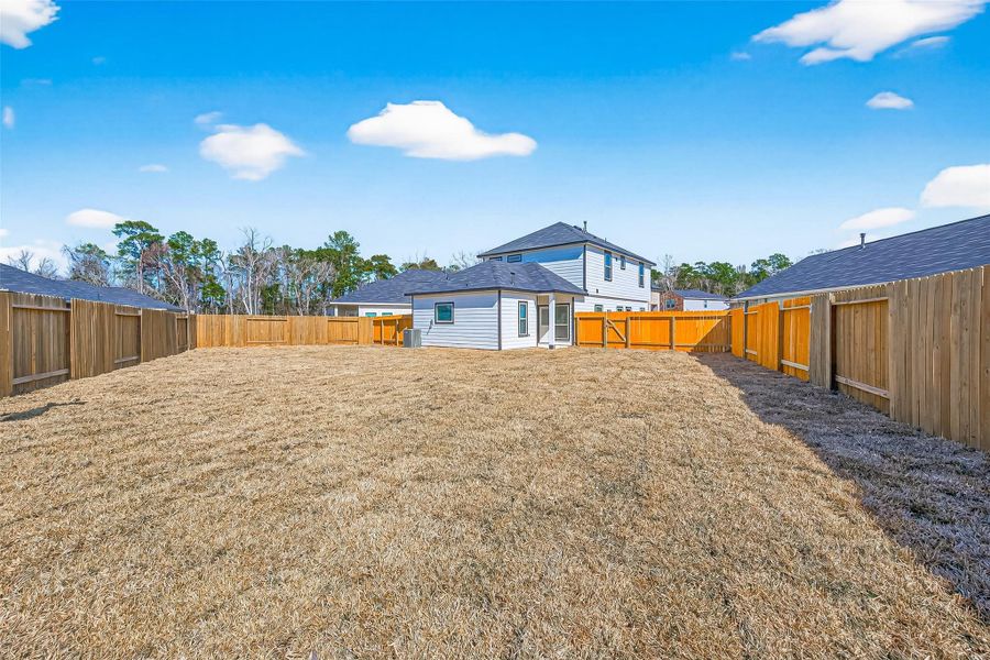 Exterior details and patio area of a home in Woodland Lakes, Huffman (Image 20).