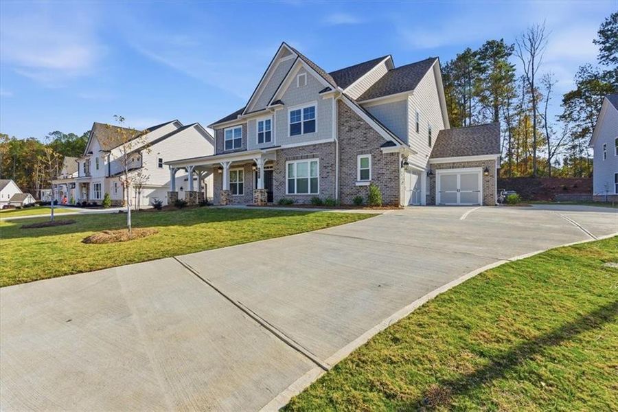 Front exterior of a new home in Ford Landing, Acworth, GA, highlighting curb appeal (Image 2). Front exterior of a new home in Ford Landing, Acworth, GA, highlighting curb appeal (Image 2).