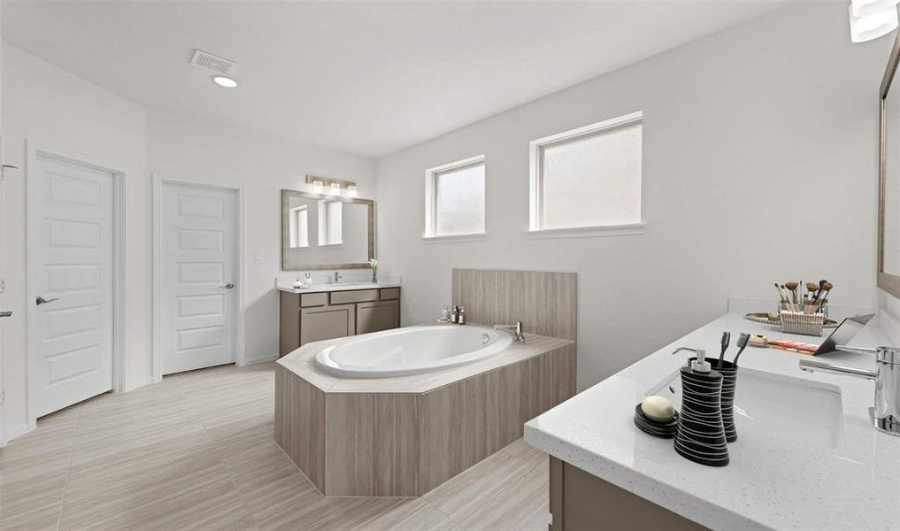 separate soaker tub and double vanities in the primary bath (*Photo not of actual home and used for illustration purposes only.)