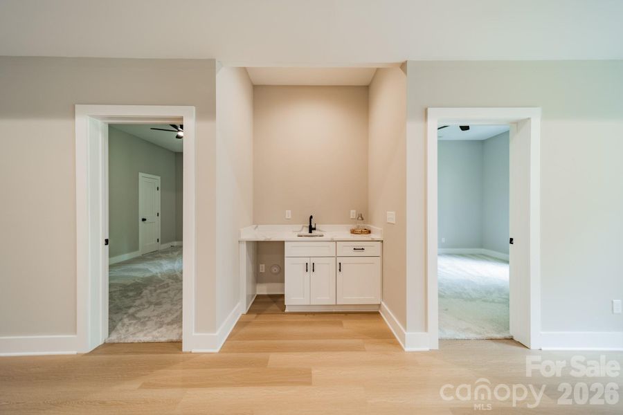 A stunning, secondary Wet Bar with ice maker (now installed) for entertaining in the Living Room of the Lower Level