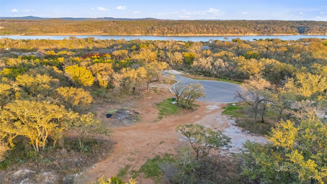 Aerial view of property and surrounding area featuring a nearby body of water