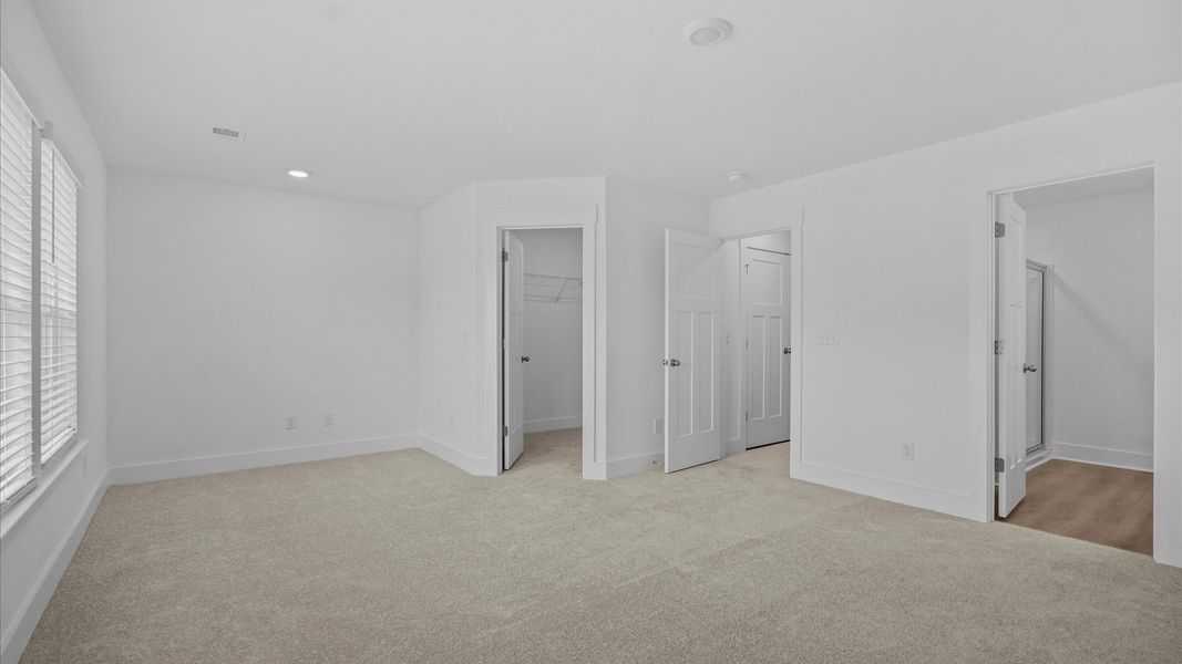 Exclusive upstairs retreat with a bright and airy primary suite with a walk-in closet Exclusive upstairs retreat with a bright and airy primary suite with a walk-in closet