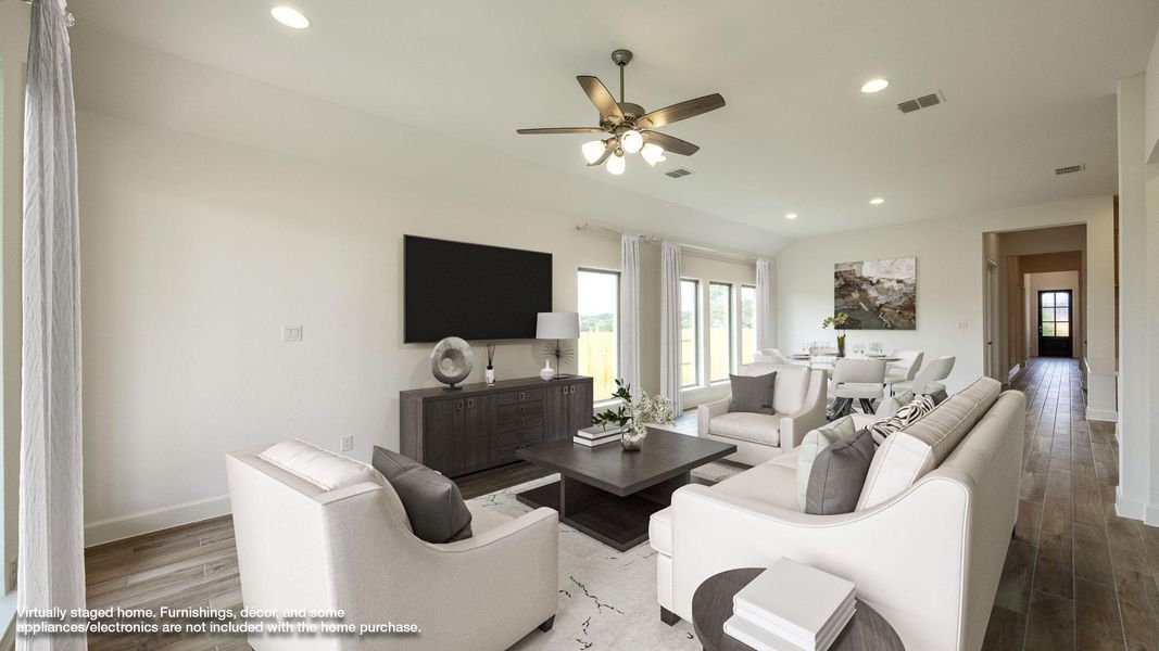 Living area with recessed lighting, wood finished floors, ceiling fan, and lofted ceiling