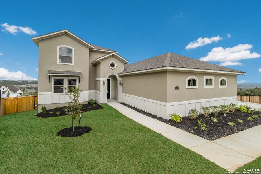 Front exterior of a new home in Johnson Ranch, Bulverde, TX, highlighting curb appeal (Image 1).
