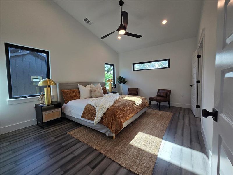 Primary bedroom with tall vaulted ceiling, lots of space and natural light.