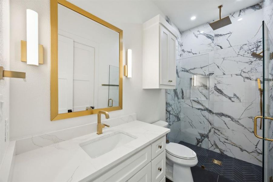 Ensuite Bathroom featuring recessed lighting, toilet, vanity, and a marble finish shower Ensuite Bathroom featuring recessed lighting, toilet, vanity, and a marble finish shower