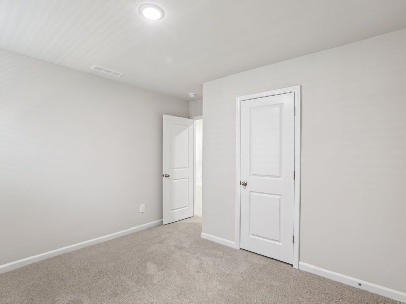Secondary bedroom in the Paisley floorplan at a Meritage Homes community in Garner, NC.