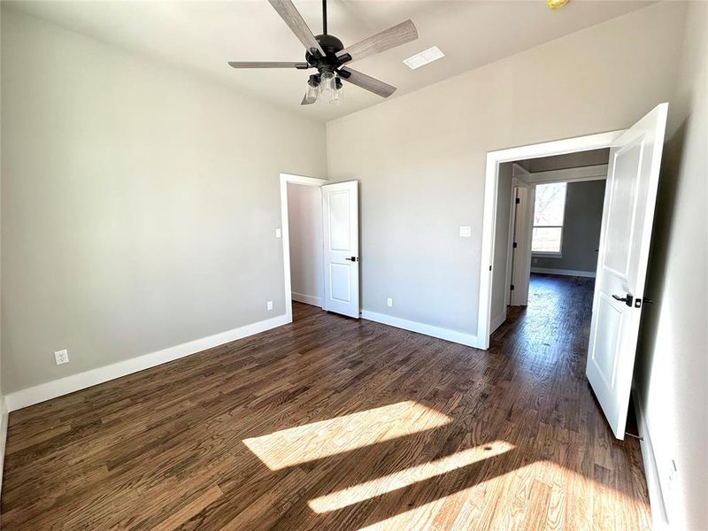 Unfurnished bedroom featuring dark wood-style flooring and ceiling fan Unfurnished bedroom featuring dark wood-style flooring and ceiling fan