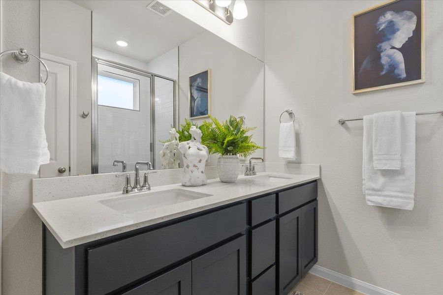 The ensuite offers a dual vanity with ample storage.