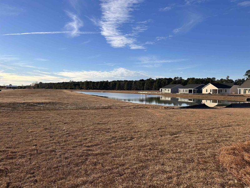 View of grassy yard with a water view