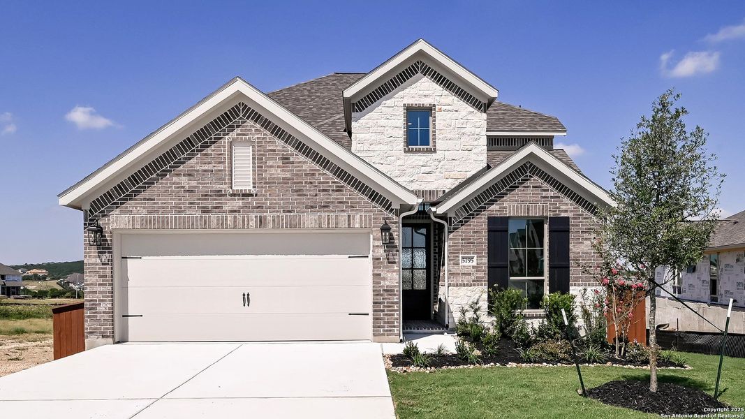 Front exterior of a new home in Homestead 55', Cibolo, TX, highlighting curb appeal (Image 26). Front exterior of a new home in Homestead 55', Cibolo, TX, highlighting curb appeal (Image 26).