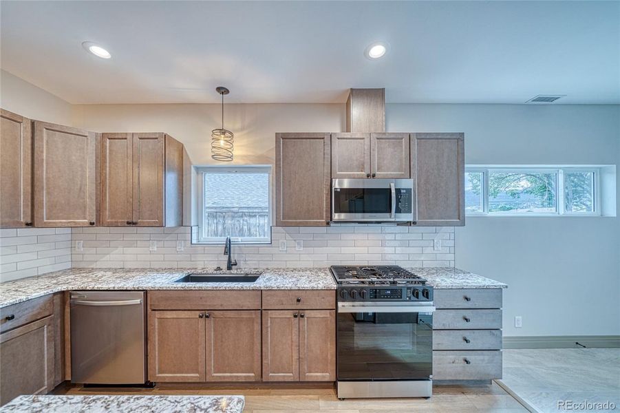 To the right of this kitchen is an additional mudroom/flex space with an exterior door to outside.