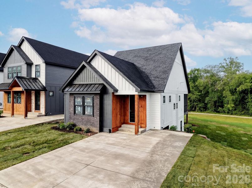 Front exterior of a new home in , Hendersonville, NC, highlighting curb appeal (Image 10). Front exterior of a new home in , Hendersonville, NC, highlighting curb appeal (Image 10).