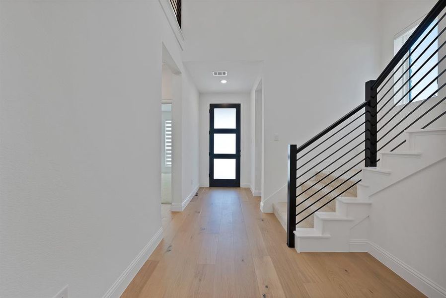 Entryway featuring light wood-finish flooring and white baseboards