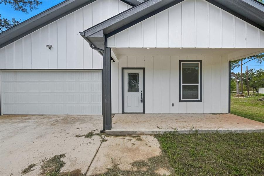 View of front of home with covered porch, an attached garage, and concrete driveway View of front of home with covered porch, an attached garage, and concrete driveway