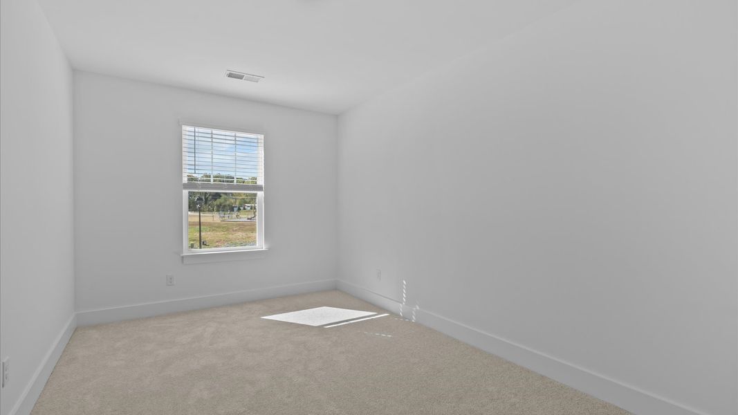 Vibrant and restful bedroom with oversized windows, refined detail, and a warm, welcoming atmosphere