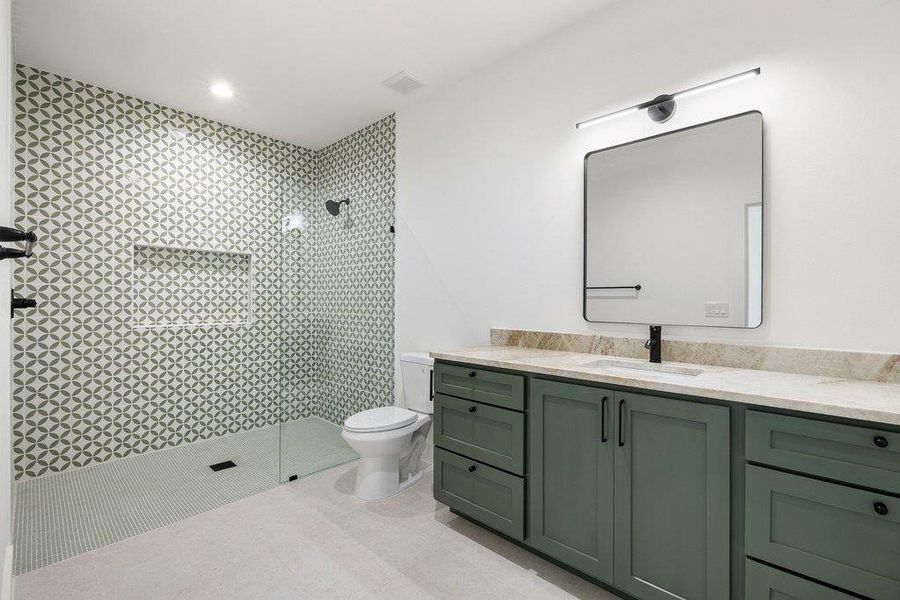 Full bath with vanity, a shower stall, and recessed lighting